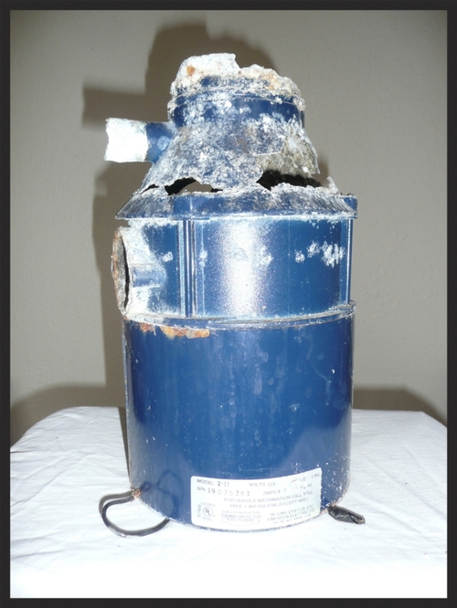 A blue gas tank sitting on top of a table.